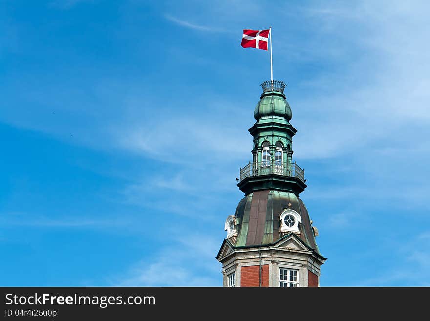 Flag of Denmark up high in the air with blue sky horizontal background