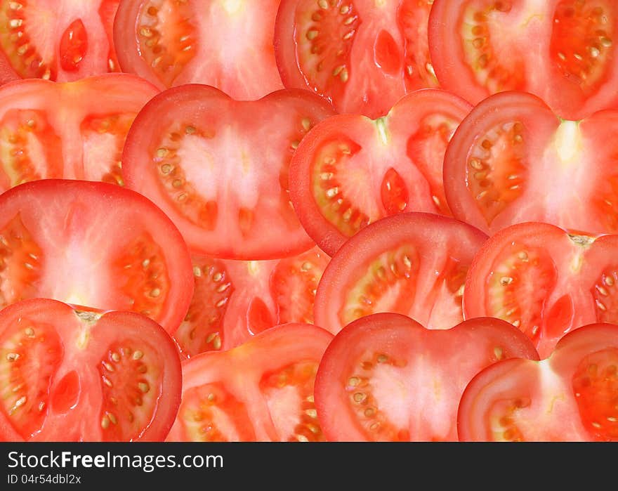 Background made from lot of freshness red sliced tomatoes. Background made from lot of freshness red sliced tomatoes