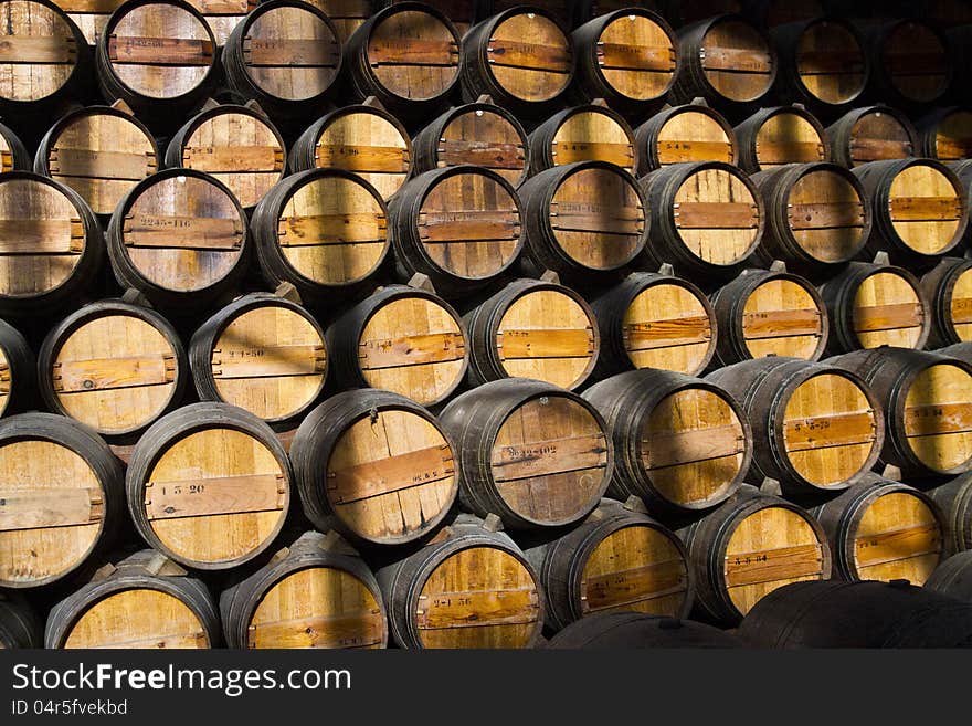 View of a bunch of wooden wine barrels on a cellar.