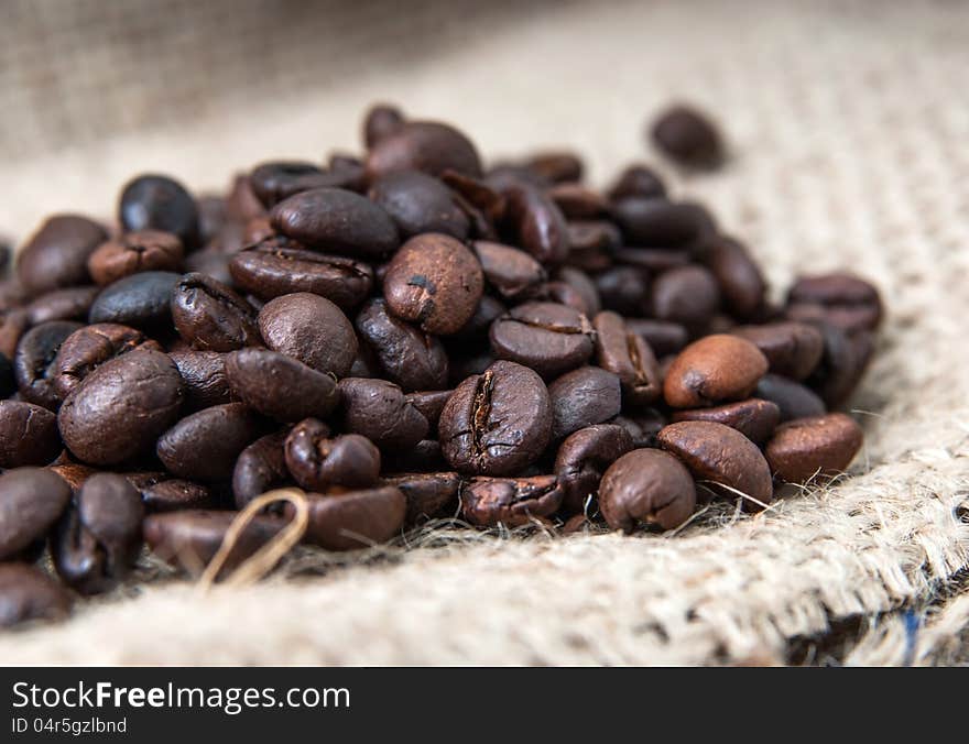 Close up of coffee beans on a burlap bag.