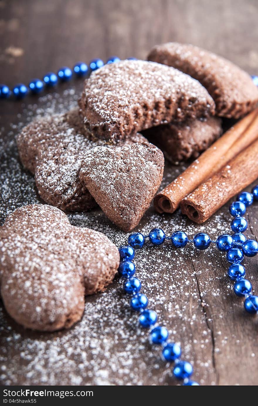 Christmas biscuits with icing sugar on wooden table