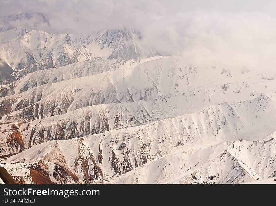 Fly over the Alaska mountain range near the Mt. McKinley peak. Fly over the Alaska mountain range near the Mt. McKinley peak