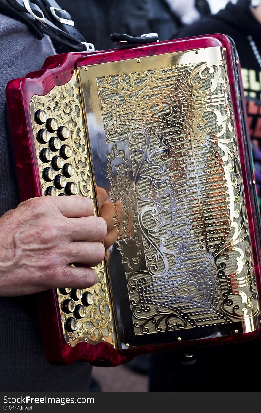 Close view of an musician playing a beautiful accordion instrument. Close view of an musician playing a beautiful accordion instrument.