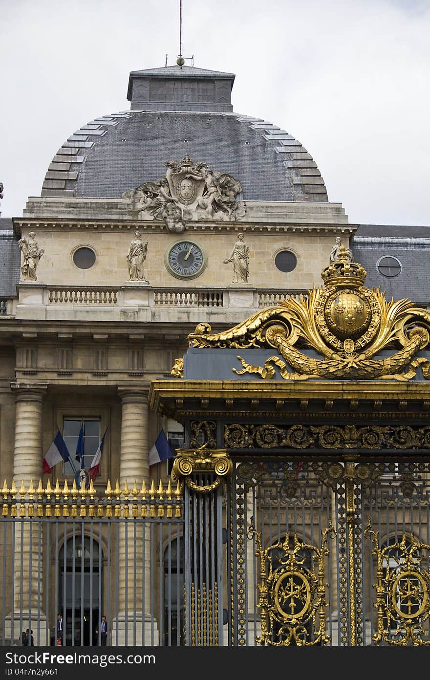 Partial view of a beautiful golden gate on a building in Paris, France.