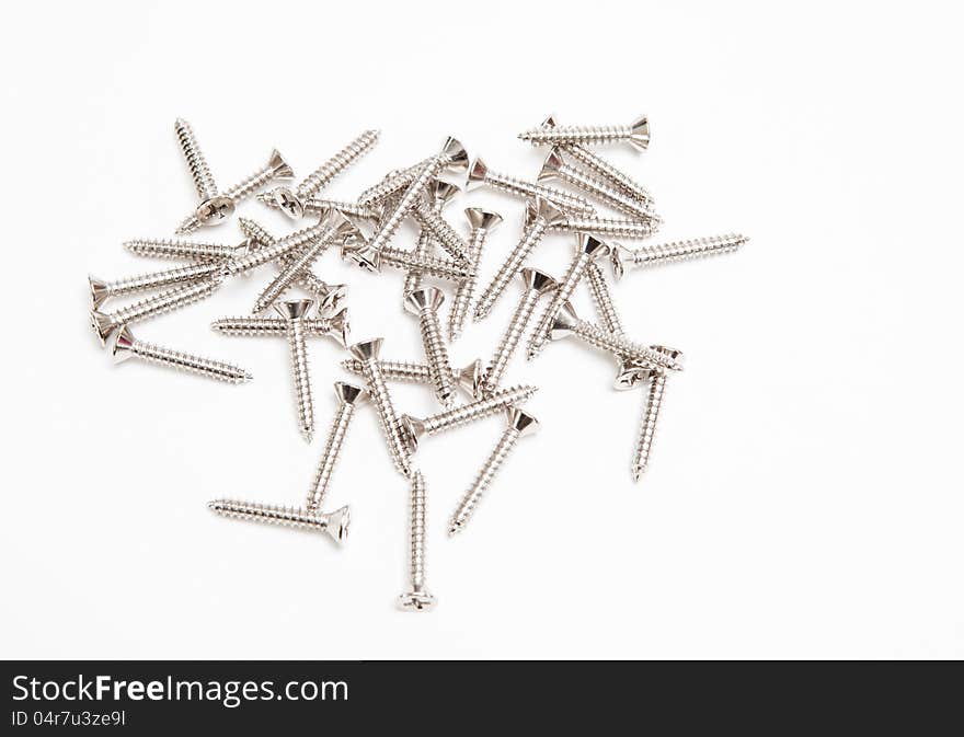 Heap of screws on white background