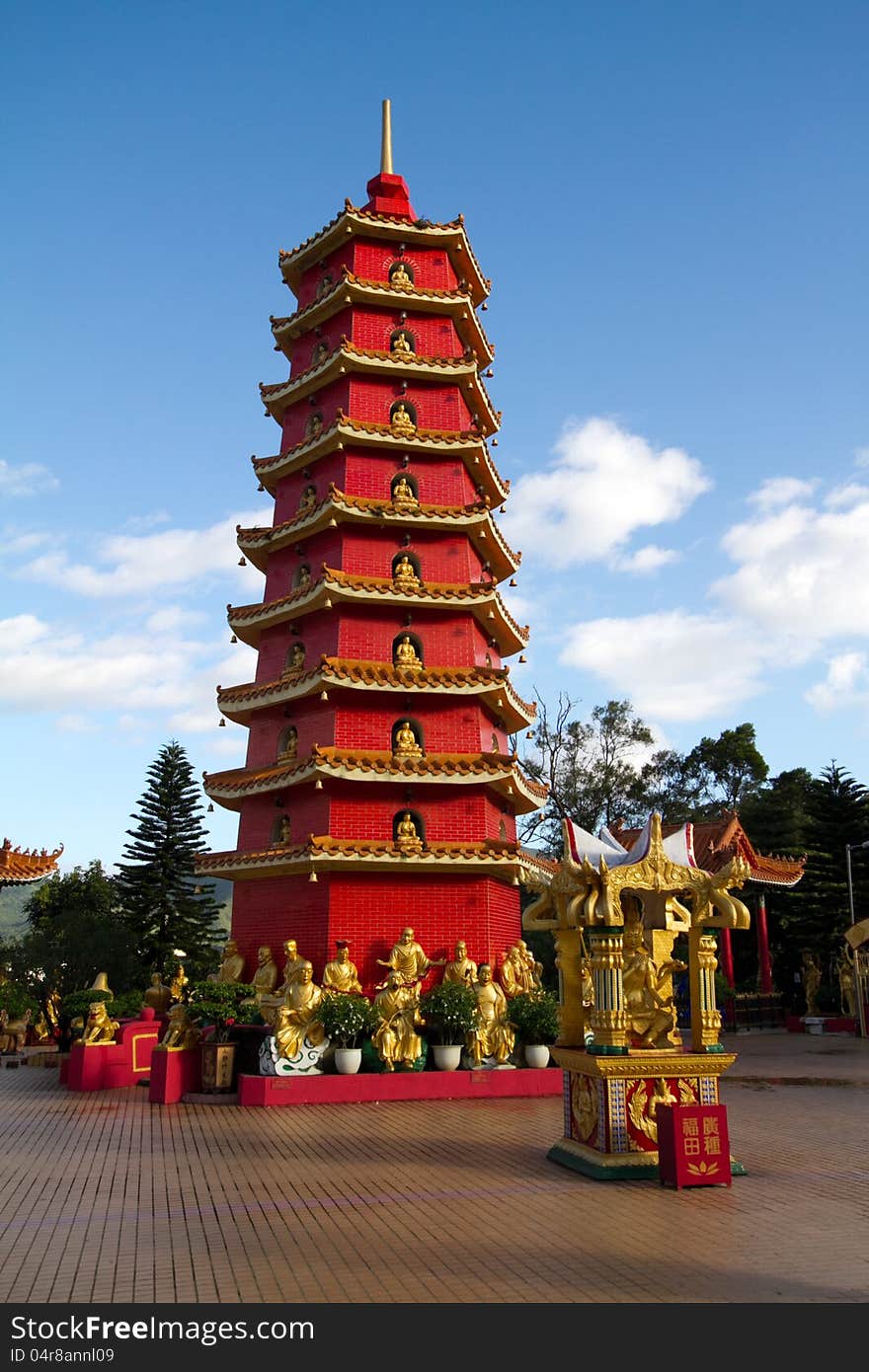 Red Chinese tower in monastery outside against the sky. Monastery of ten thousand Buddhas in Gonkong, China.