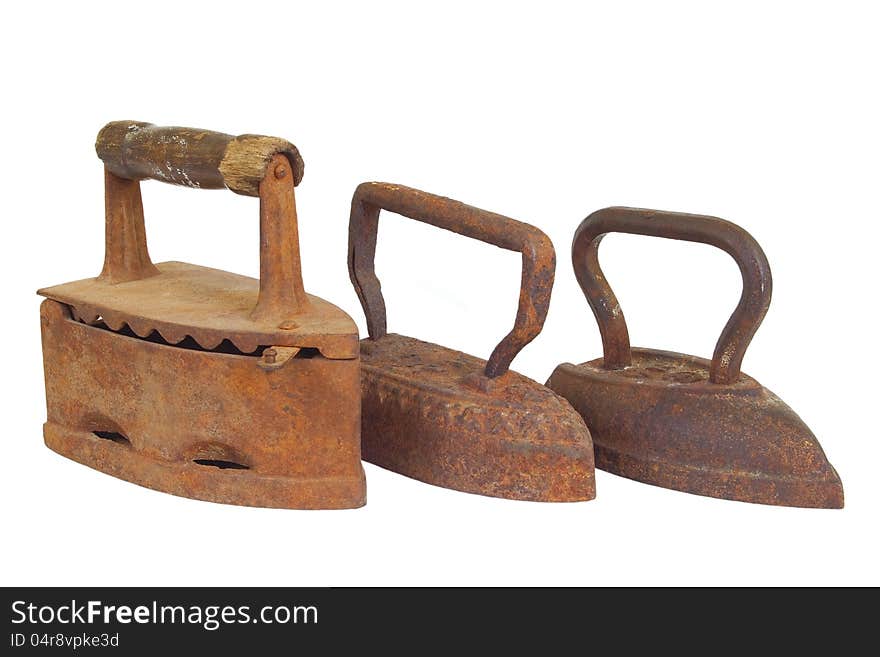 Three old metal iron on a white background. Three old metal iron on a white background