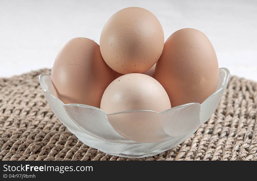 Eggs in glass bowl  on the table