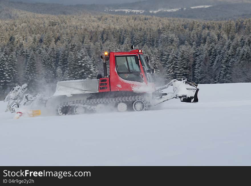 Snowplow working on a ski slope. Snowplow working on a ski slope