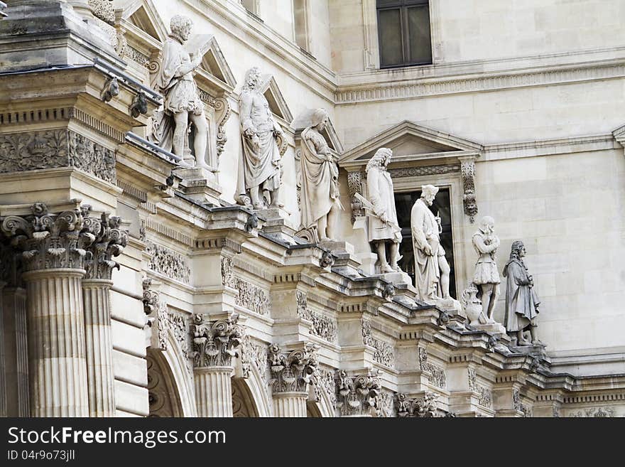 Beautiful statues located on the Museum of the Louvre in Paris, France