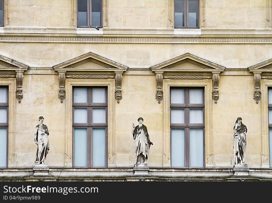 Beautiful Statues Located On The Museum Of The Louvre In Paris, France