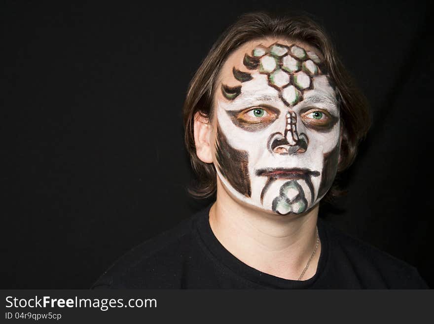 Halloween. Make-up of a dragon on a man's face. Halloween. Make-up of a dragon on a man's face.