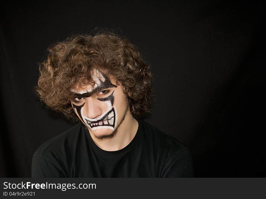 Halloween. Make-up on a face of the young man