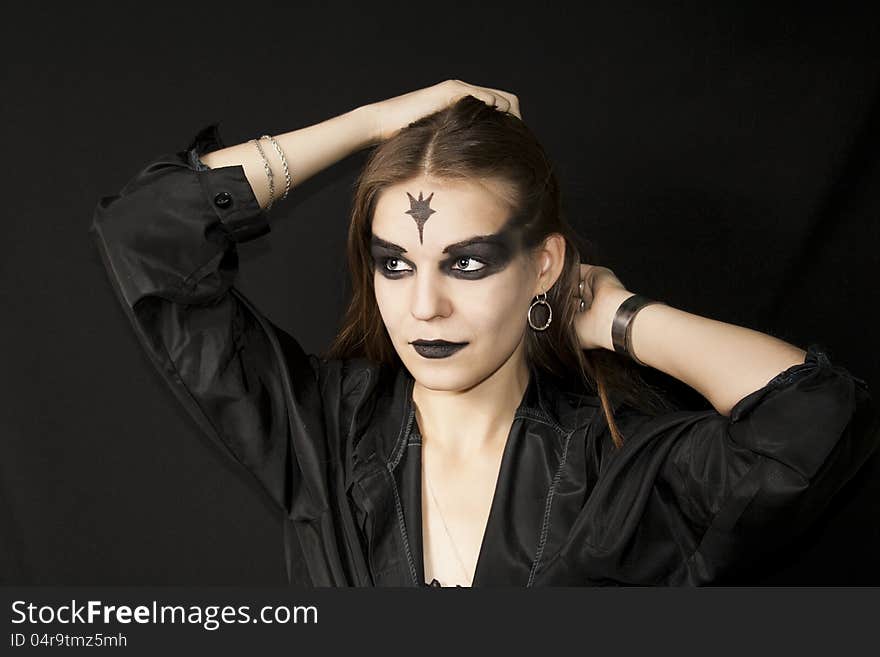 Halloween. Gothic girl with a black make-up of eyes and lips. Halloween. Gothic girl with a black make-up of eyes and lips