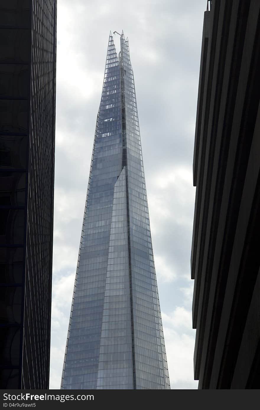 The London Shard framed either side by tall city buildings. The London Shard framed either side by tall city buildings