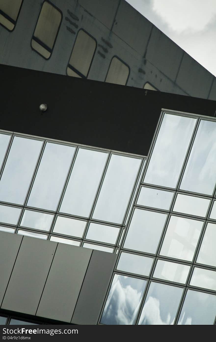 View of a modern and shiny glass skyscraper. View of a modern and shiny glass skyscraper.