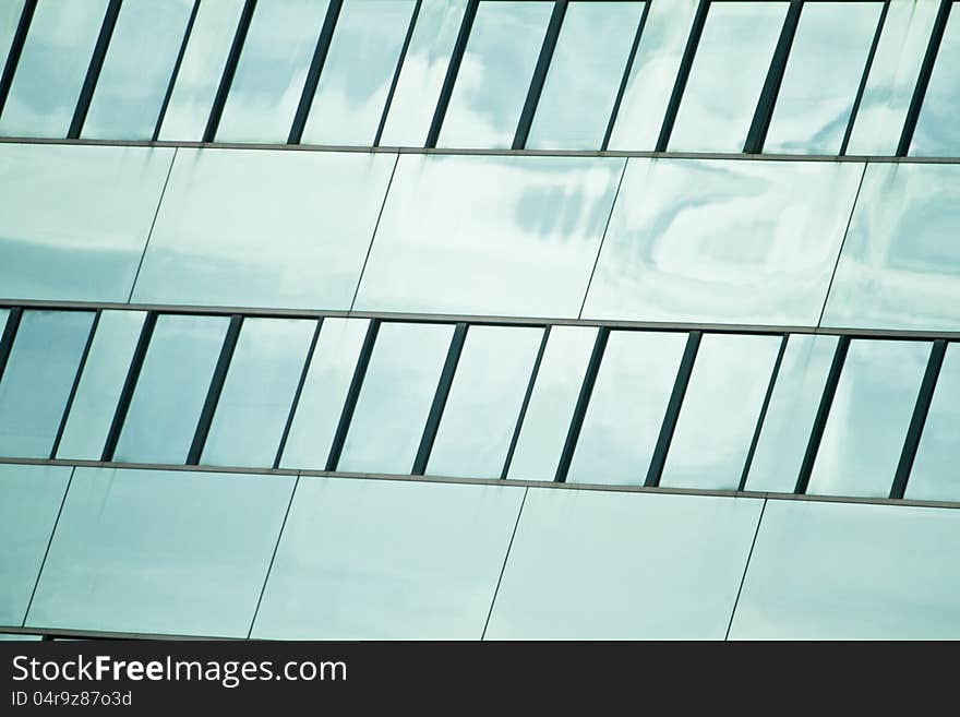 View of a modern and shiny glass skyscraper. View of a modern and shiny glass skyscraper.