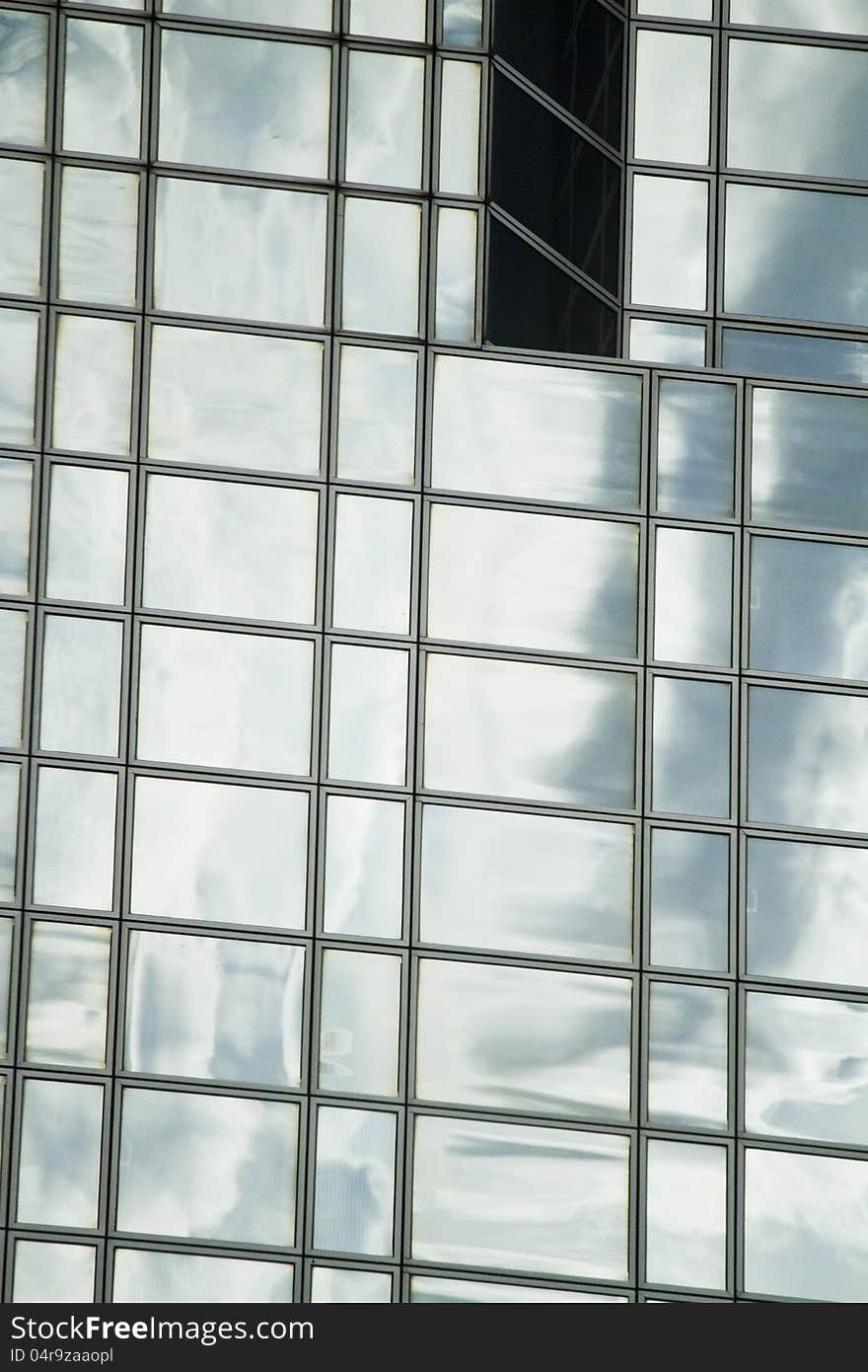 View of a modern and shiny glass skyscraper. View of a modern and shiny glass skyscraper.