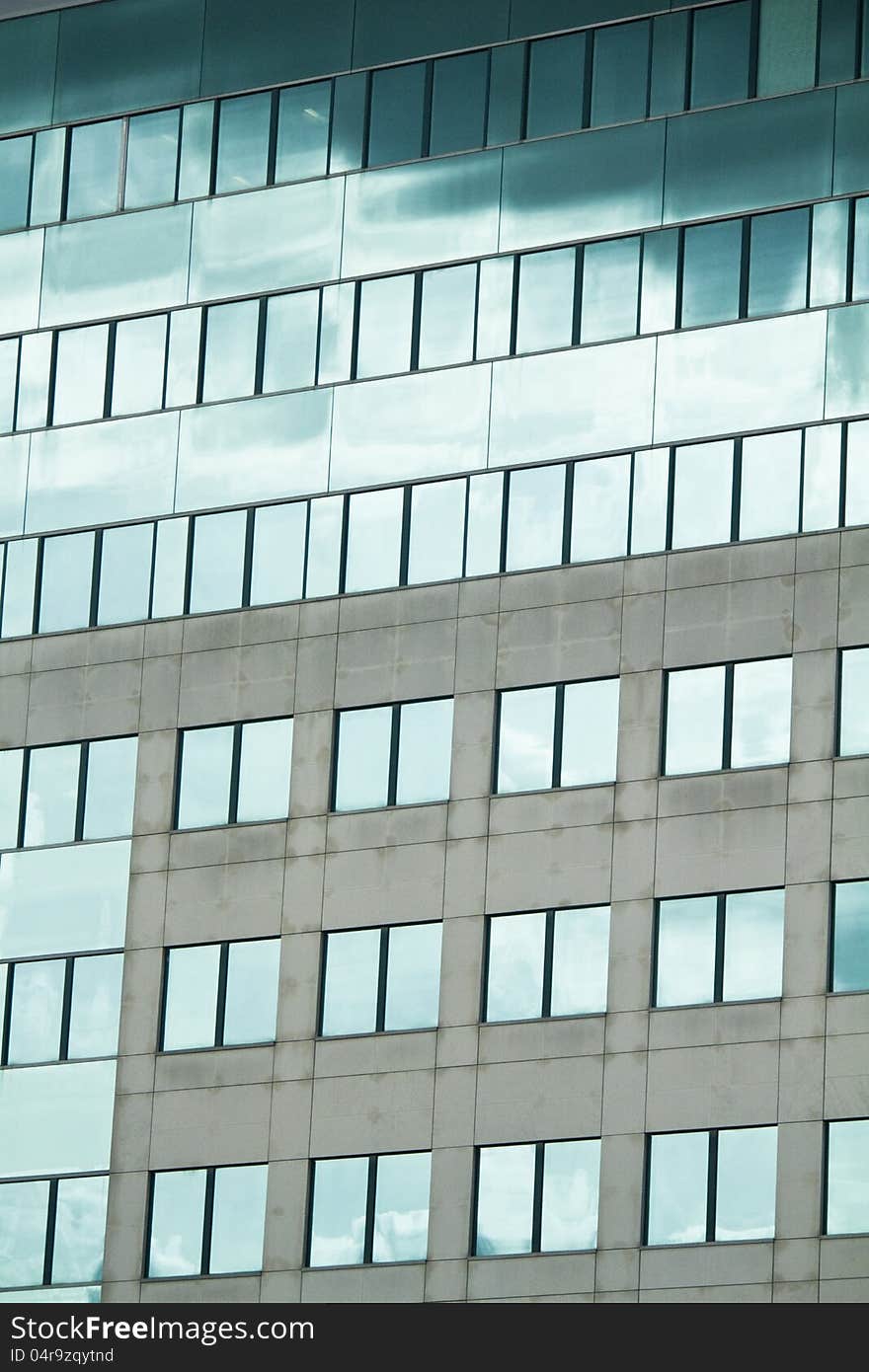 View of a modern and shiny glass skyscraper. View of a modern and shiny glass skyscraper.