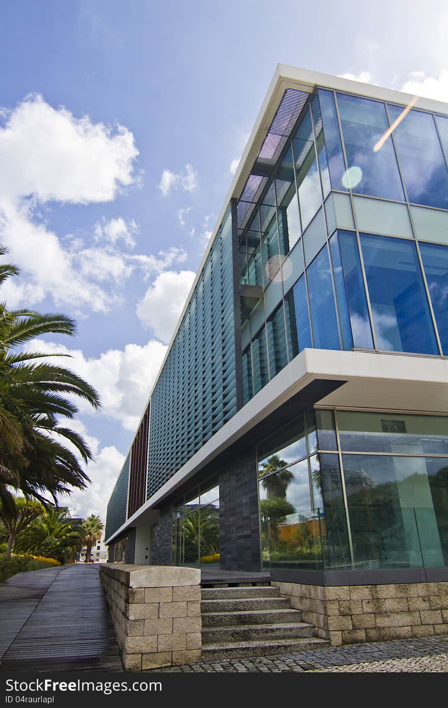 View of a modern glass building in the Parque das Nacoes area in Lisbon, Portugal. View of a modern glass building in the Parque das Nacoes area in Lisbon, Portugal.