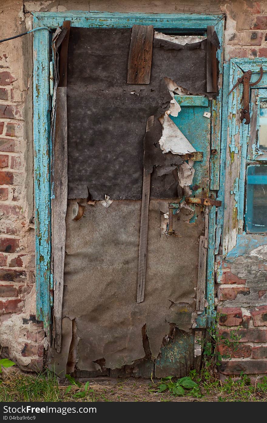 Very old dilapidated ragged door