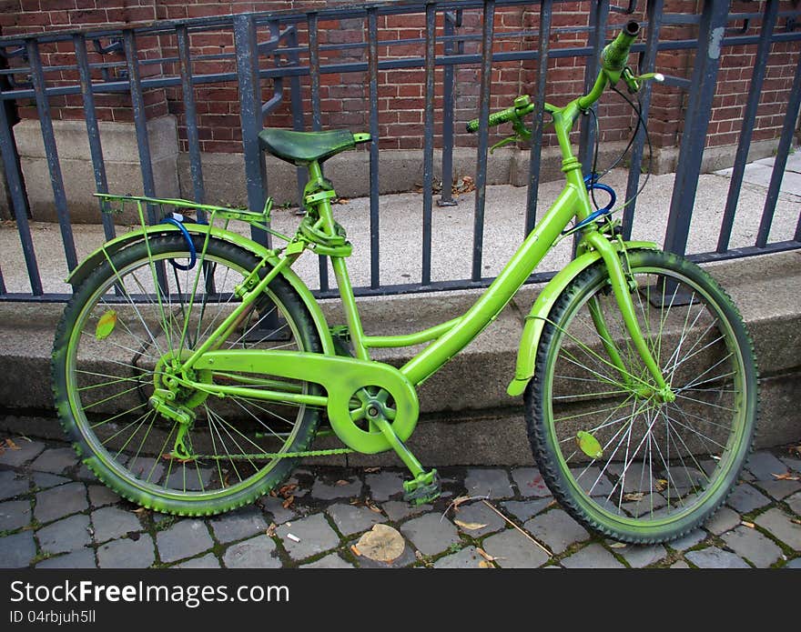 Vintage beauty green bicycle on a street. Vintage beauty green bicycle on a street