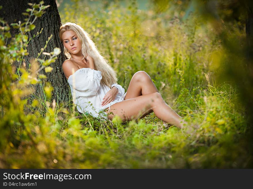 Young woman on field in white dress