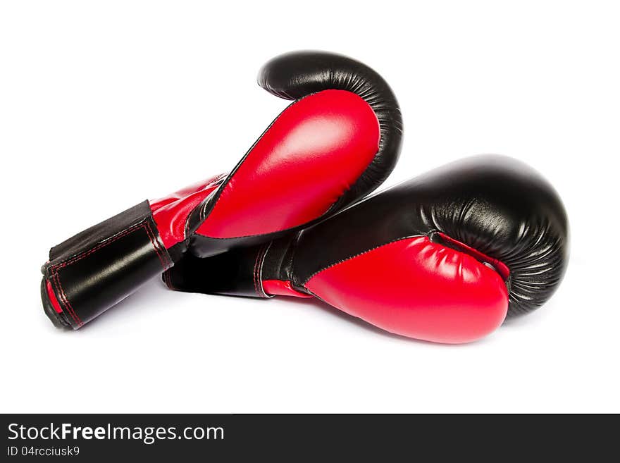 Close view of some red boxing gloves isolated on a white background.