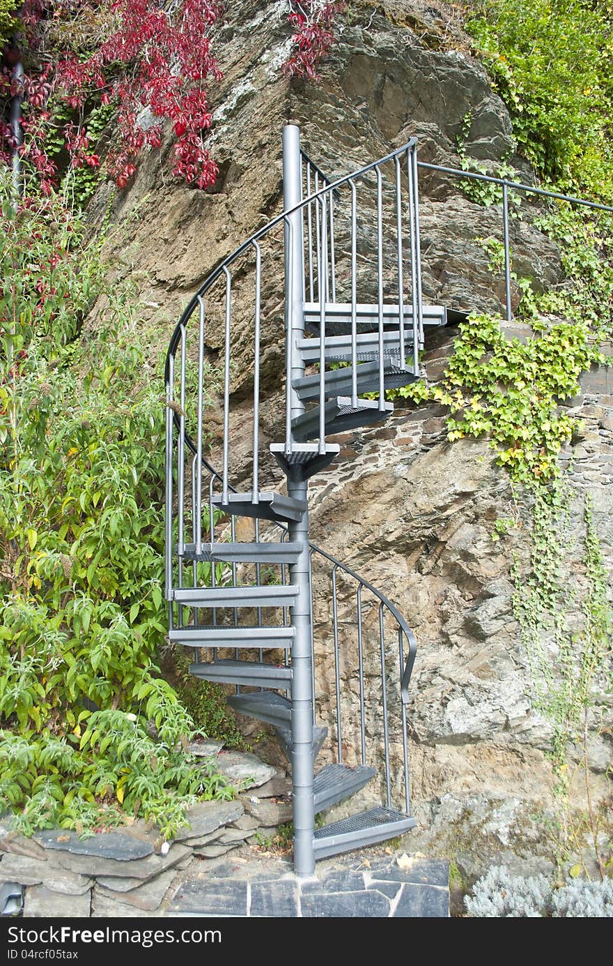 Spiral stairs in an autumn garden