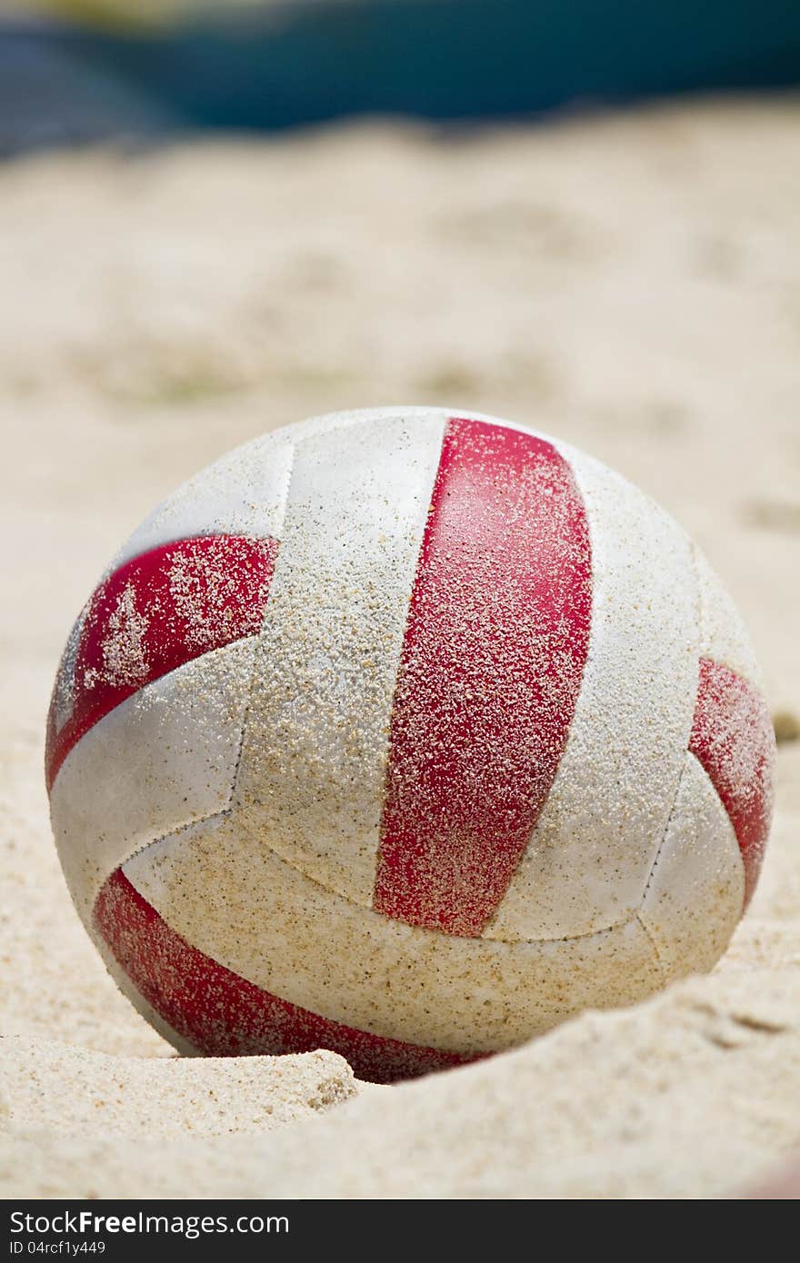 Close view detail of a beach ball covered in sand on a beach. Close view detail of a beach ball covered in sand on a beach.