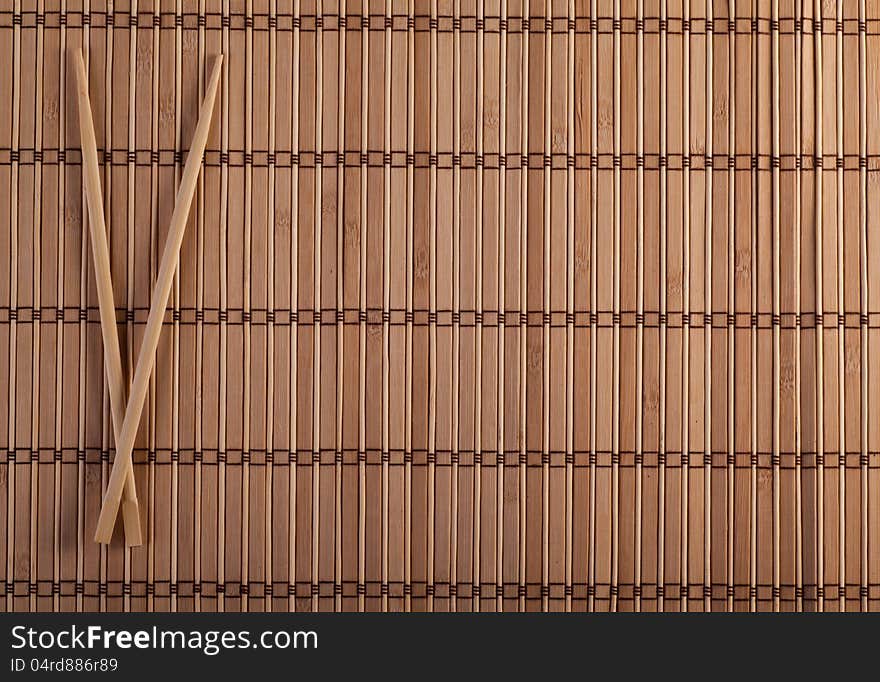 Two chopsticks on sushi background