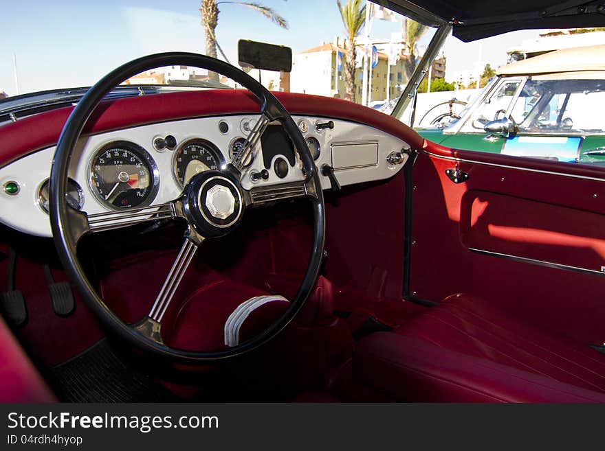 Detail view of the interior of a vintage car on display on a city. Detail view of the interior of a vintage car on display on a city.