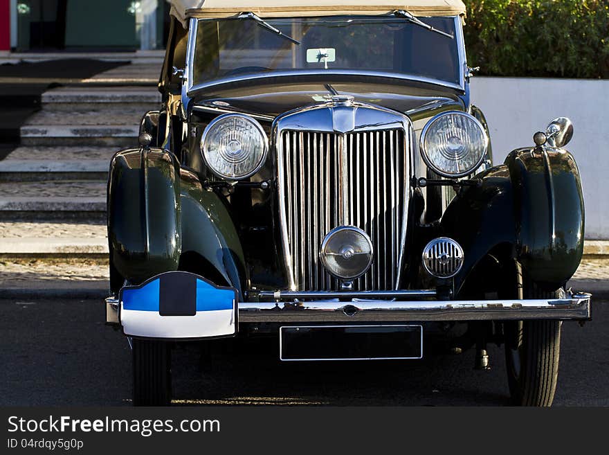 Detail view of a vintage car on display on a city. Detail view of a vintage car on display on a city.