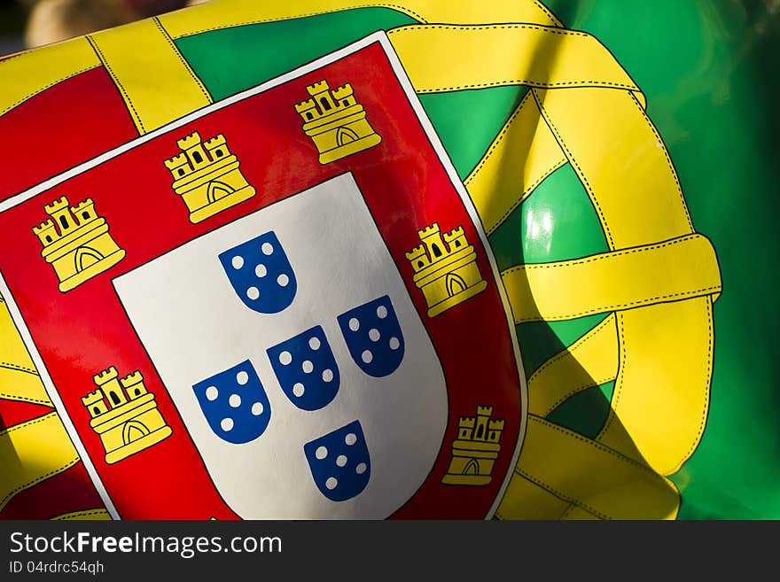 Close up view of a Portuguese flag pattern on a surface.