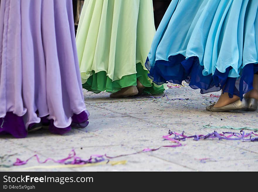 View of some girls with colorful dresses dancing on the Carnival festivity. View of some girls with colorful dresses dancing on the Carnival festivity.