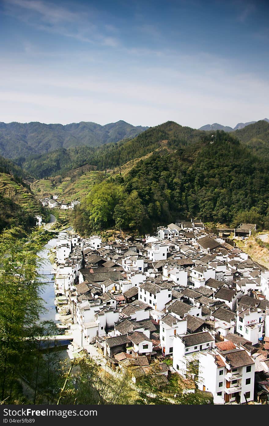 This photo captures the scene of the whole village which is built along a small river from the other side. This photo captures the scene of the whole village which is built along a small river from the other side.