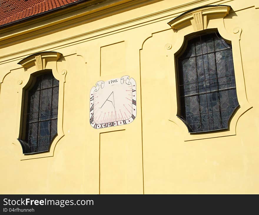 The sundial on the yellow wall of the old church. The sundial on the yellow wall of the old church.