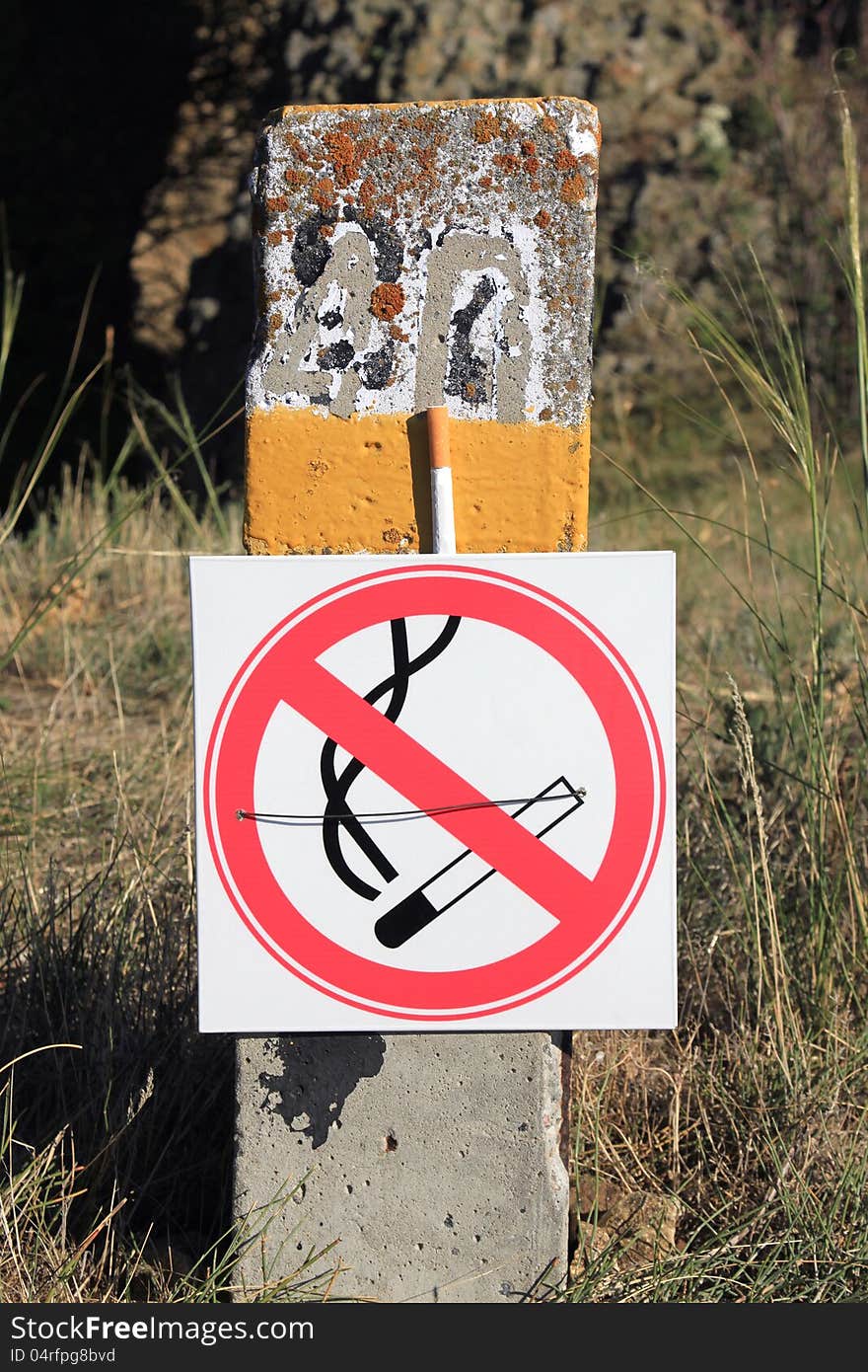 No smoking. Signs on pillar with cigarette