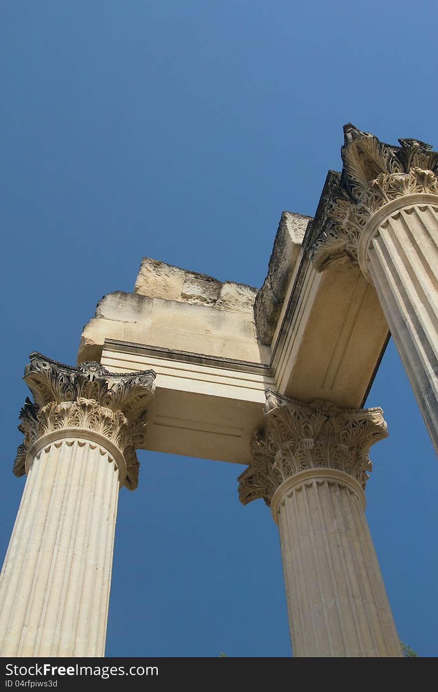 Roman pillars in Glanum (France). Blue sky in the background. Roman pillars in Glanum (France). Blue sky in the background.