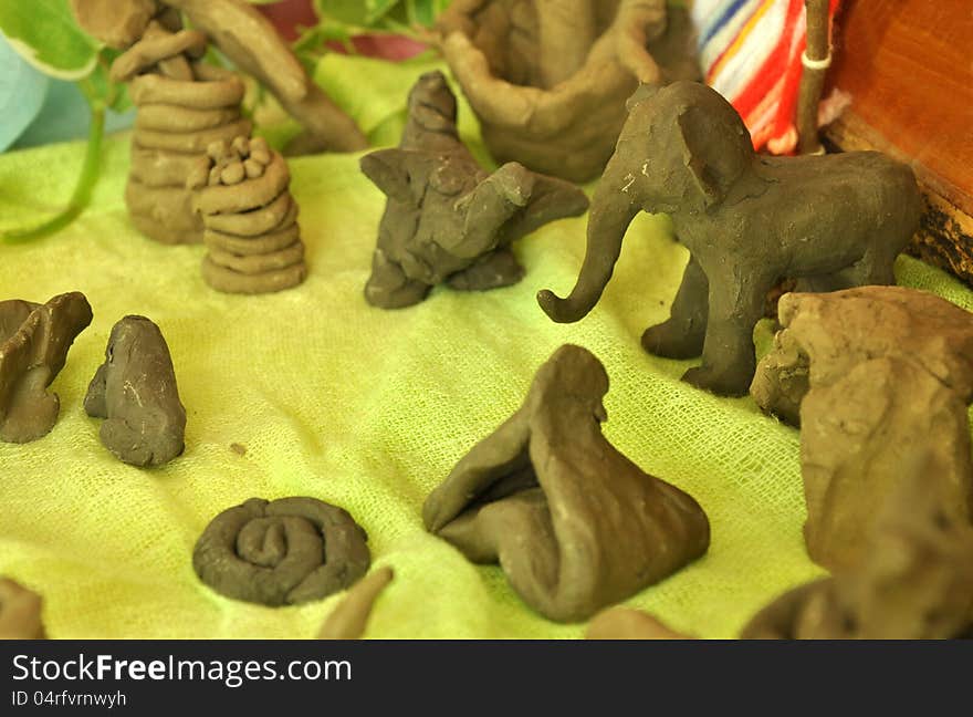 Kid's arts moulding from clay look like elephent in art classroom. Kid's arts moulding from clay look like elephent in art classroom