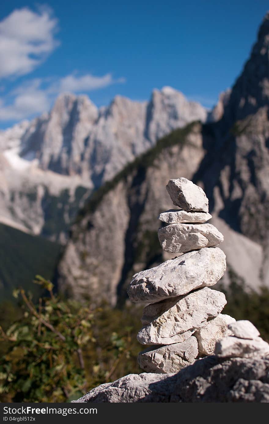 Stack stone with not in focus background high Alp mountains. Stack stone with not in focus background high Alp mountains