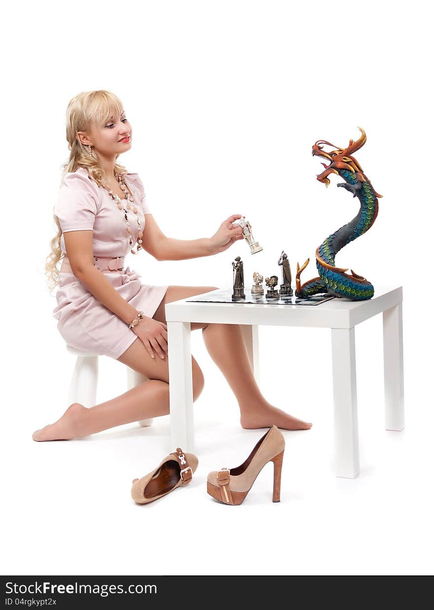 girl playing chess with a decorative dragon