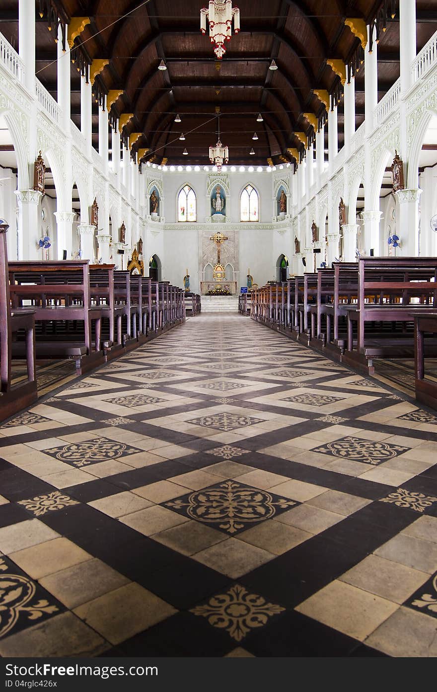 An aisle between rows of seats in a church. An aisle between rows of seats in a church