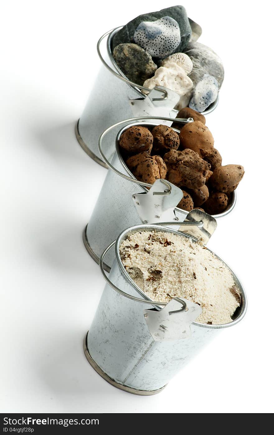 Three Tin Buckets with Gravel, Sand and Stones in a Row isolated on white background. Three Tin Buckets with Gravel, Sand and Stones in a Row isolated on white background