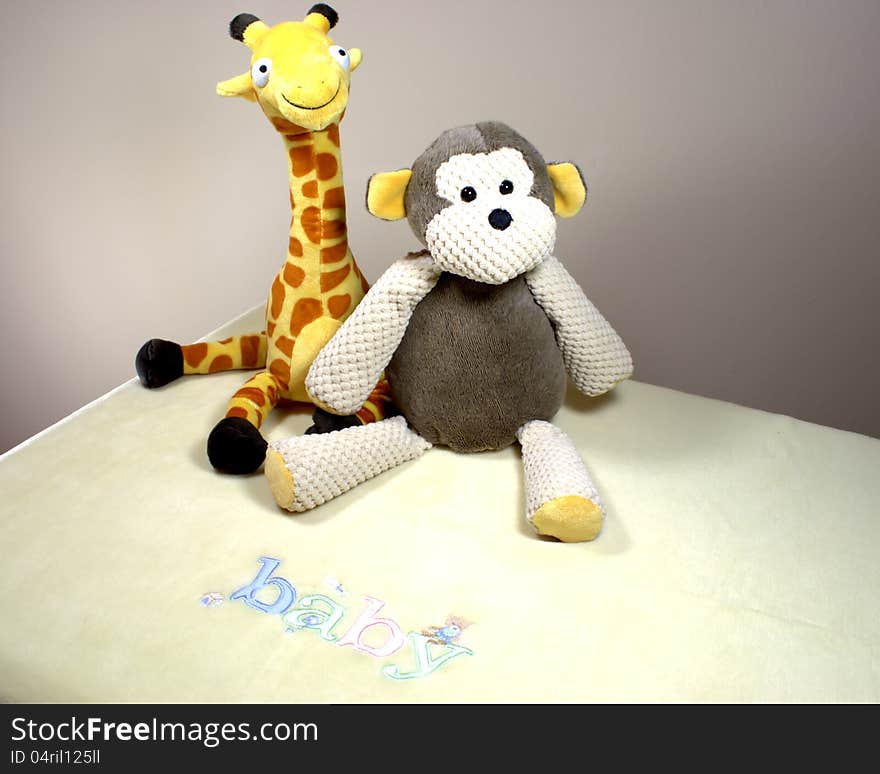 Monkey and giraffe on a yellow baby blanket. Monkey and giraffe on a yellow baby blanket