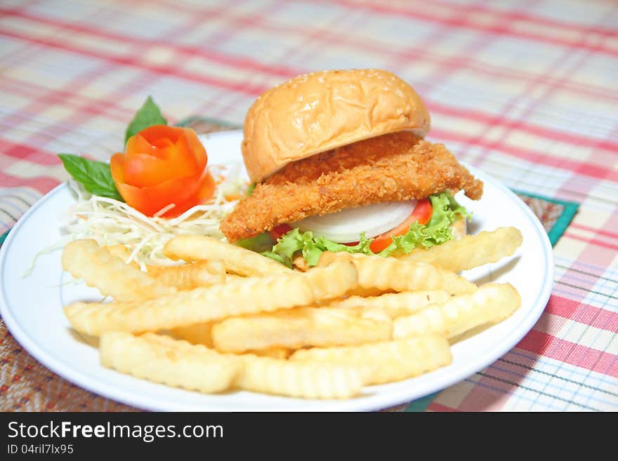 Deep fried chicken burger with fench fire on white plate. Deep fried chicken burger with fench fire on white plate