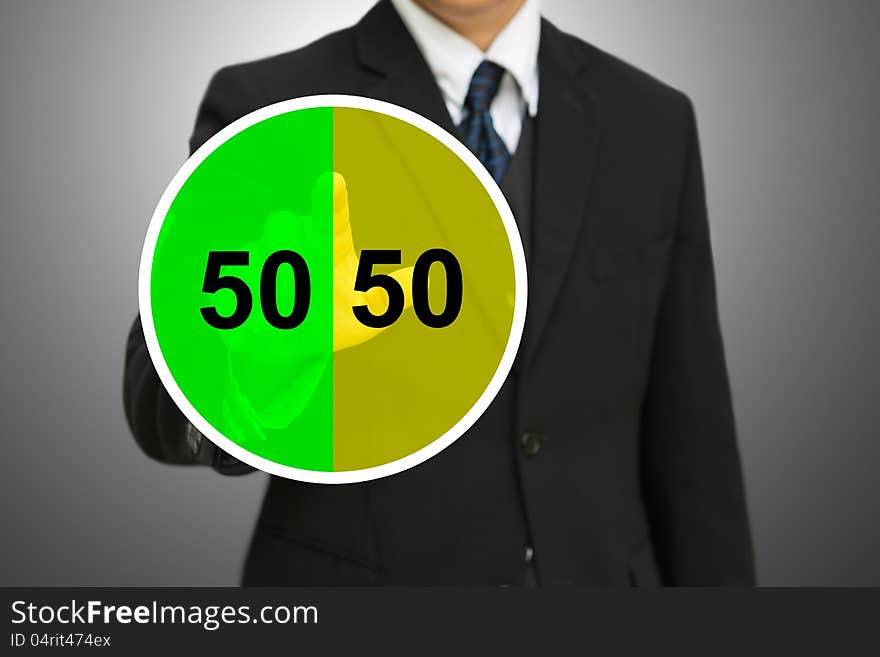 Business man touching on Pie chart with fifty-fift