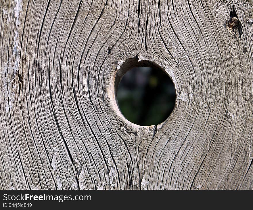 The hole in the wooden fence.