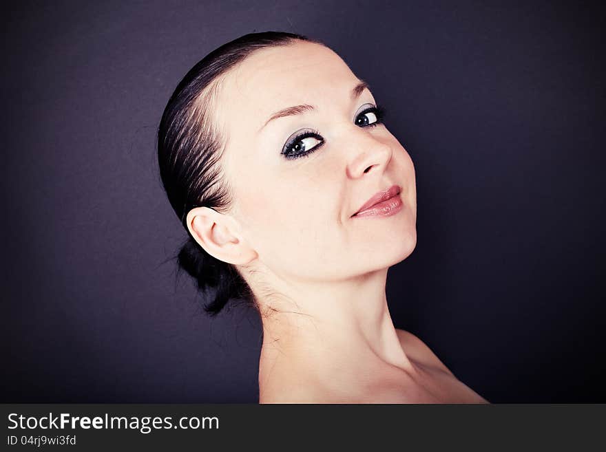 Pretty brunette girl on dark background