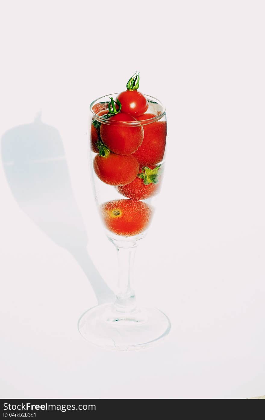 Little red tomatoes into the glass